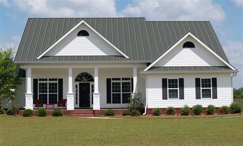 white house with charcoal gray metal roof|white house shingle roof.